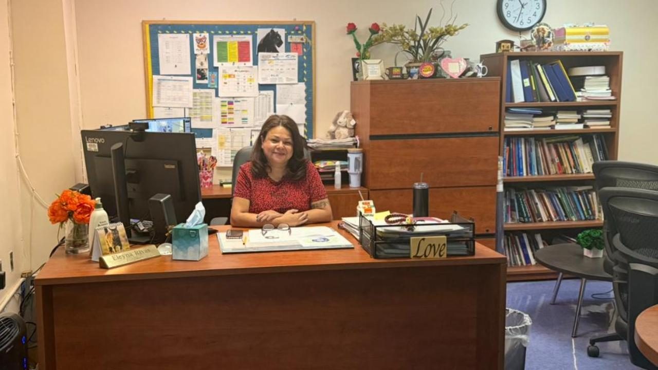 The principal at her desk in the P169M main office